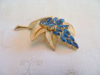 Crown Trifari goldtone flower brooch with marquise Montana Blue 