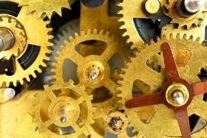The bright gold gears of a mechanical watch movement