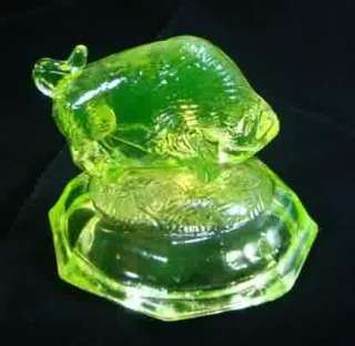   Yellow Vaseline Glass Buffalo, Bison Paperweight standing on a mound