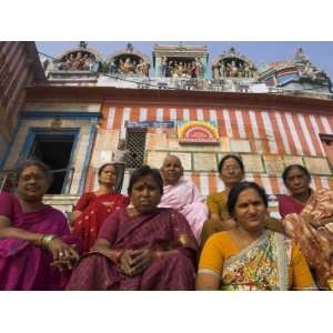 Group of Women Pilgrims Sitting on the Steps of Kedar Ghat with Temple 